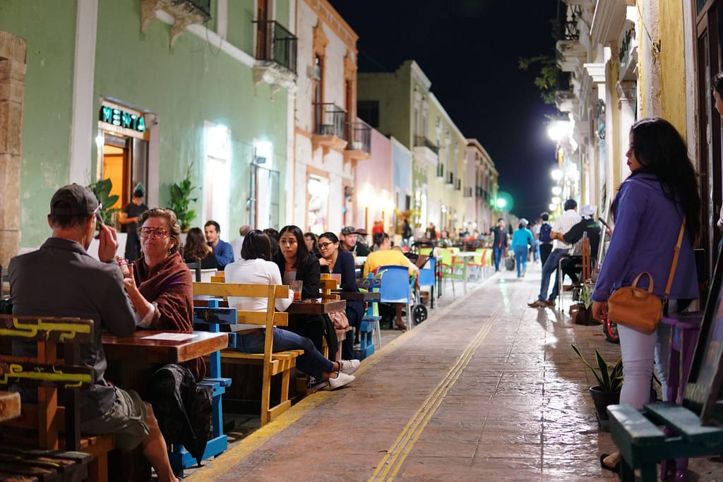 Street dining at tables in evening