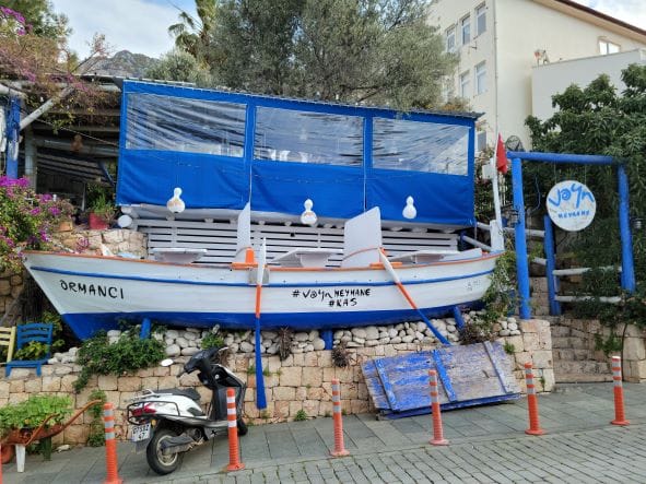 Boat advertising restaurant on streets of Kas